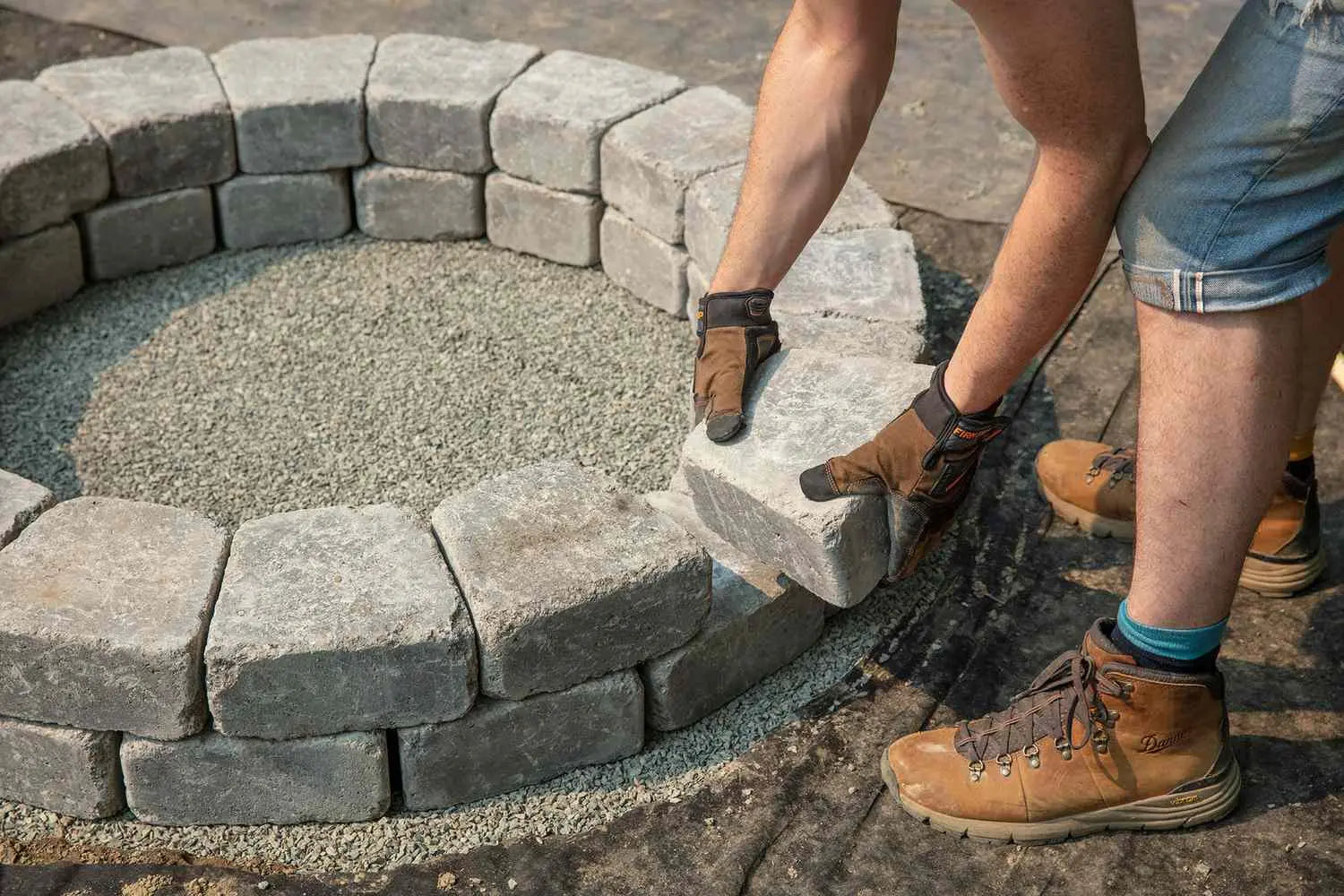 Man putting together Summit fire pit in colour Vision.