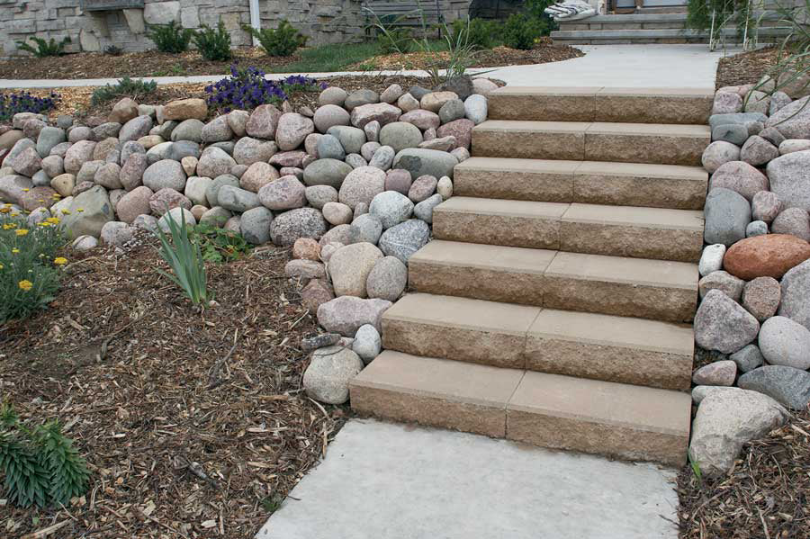 Passageways Stepping Units Product Photo Walkway and a staircase made with Passageway Stepping Units surrounded by a rock bed and boulders