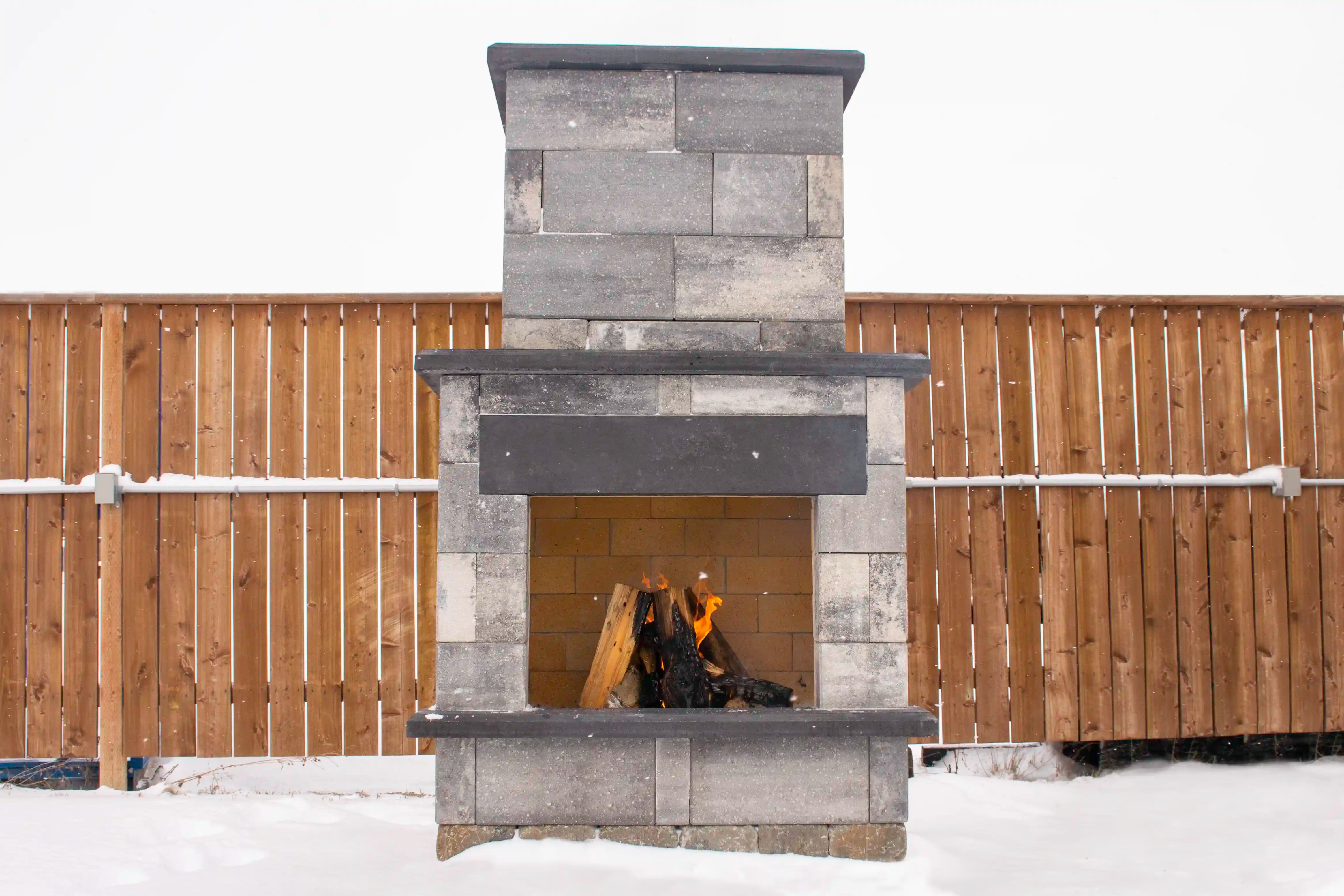 Smooth Metropolitan Fire Place in majestic grey and obsidian accents with a fire going inside.