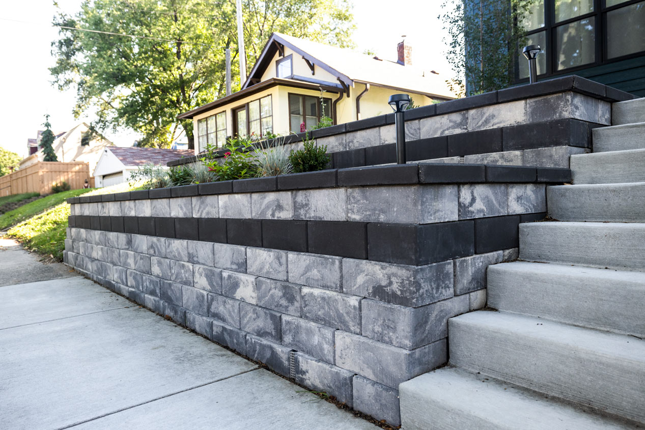 Unique and easy to install Tribute wall in colour Allure and accents in colour Reflection. Retaining wall with built in planters and stairs.