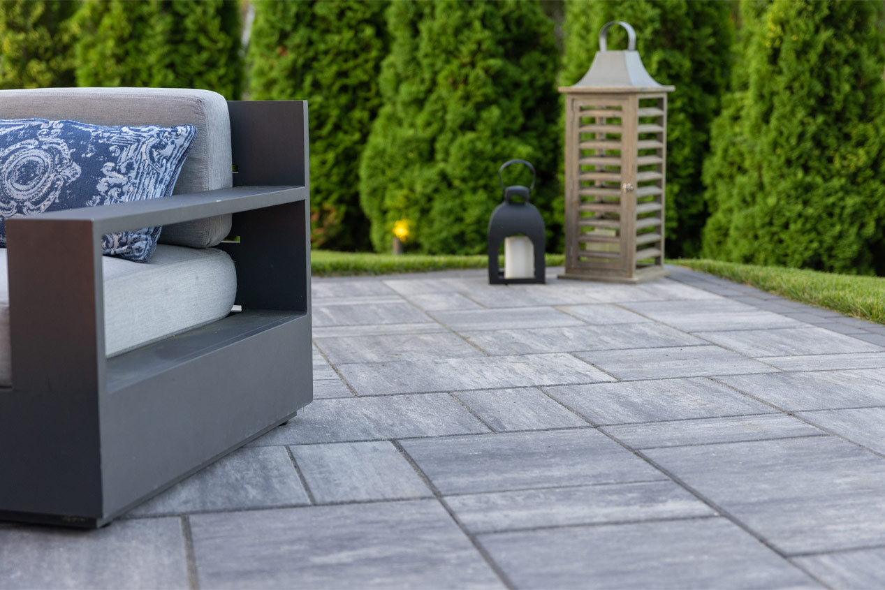 Patio Chair and lighting on a patio installed with Grand Discover Pavers