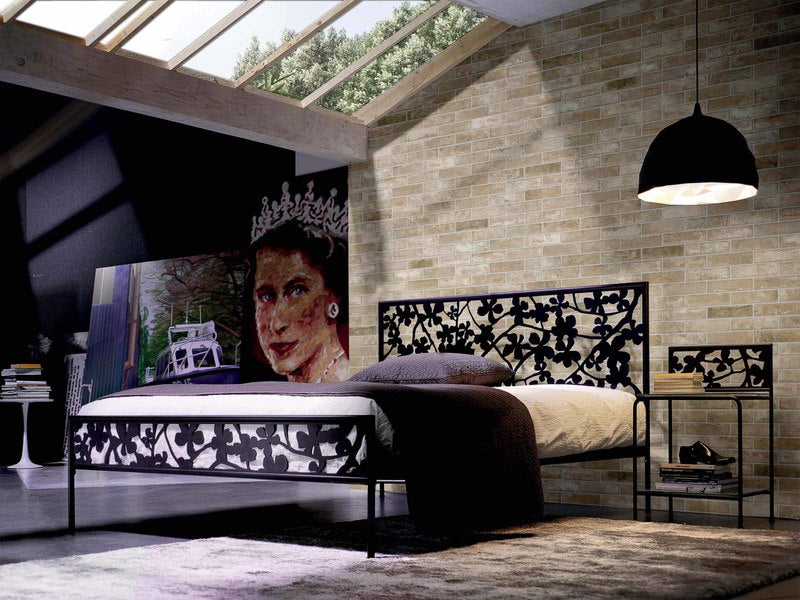 Bedroom with a skylight and a mural featuring a wall with Brickone Porcelain Tiles in Vecchia Firenze installed on it.