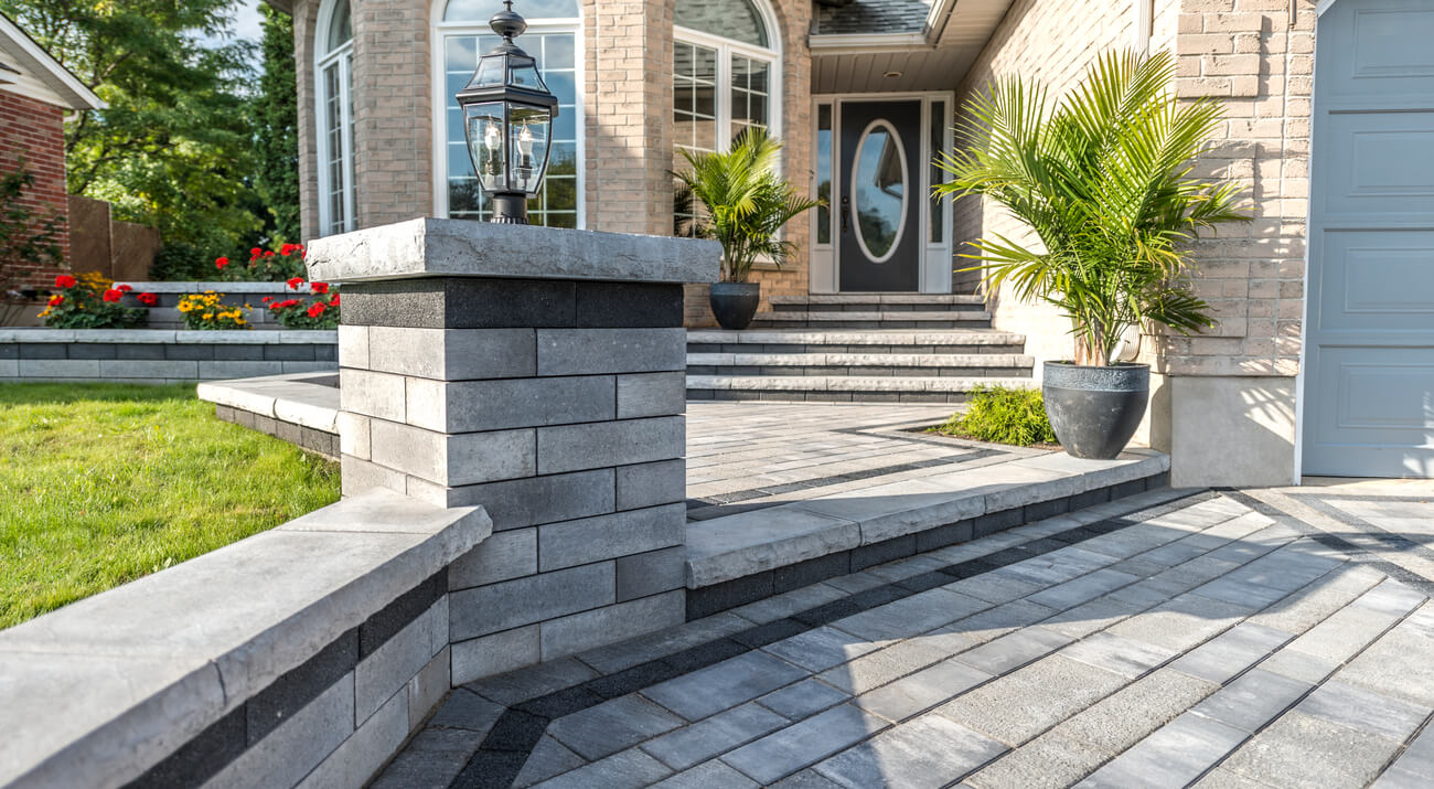 Retaining wall with Unity pavers in colour majestic. Raised Patio and steps adding levels to your patio.
