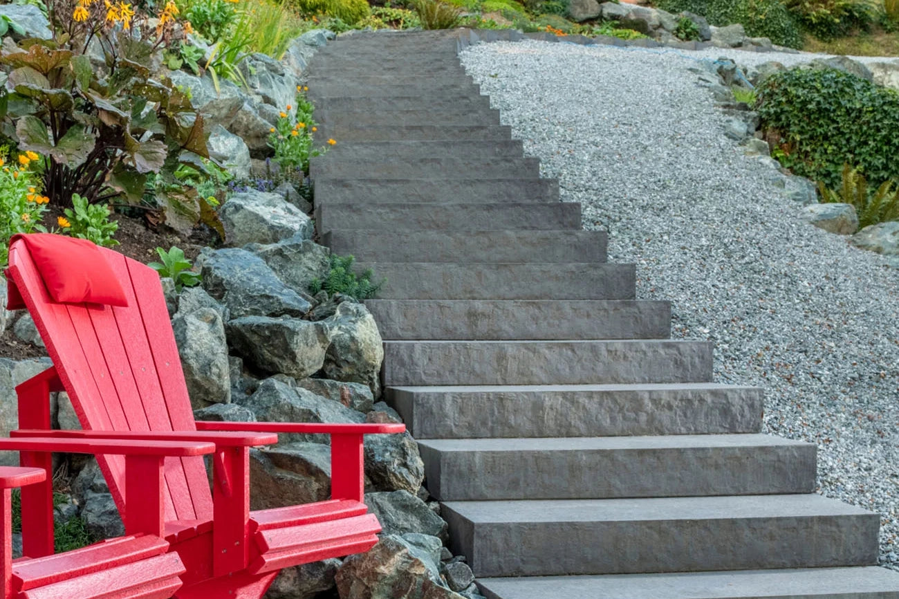 Walkway and a staircase made with Passageway Stepping Units surrounded by a rock bed and boulders