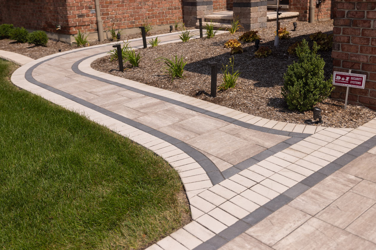 Welcoming curved walkway made with Element pavers in colour Enlighten. Finished with a contrasting border in colours Reflection and Vision.