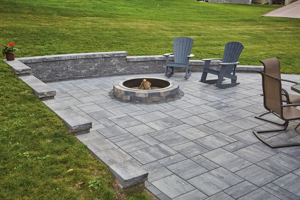 Summit Round Fire Pit on a Majestic Patio with a retaining wall.