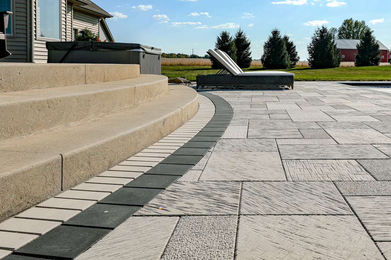 Steps going down to a patio made with grand Fusion Pavers and featuring a double border style.