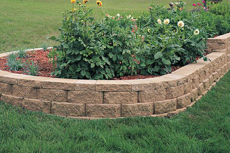 Raised flower bed with a retaining wall and Windsor Wall Cap in top/