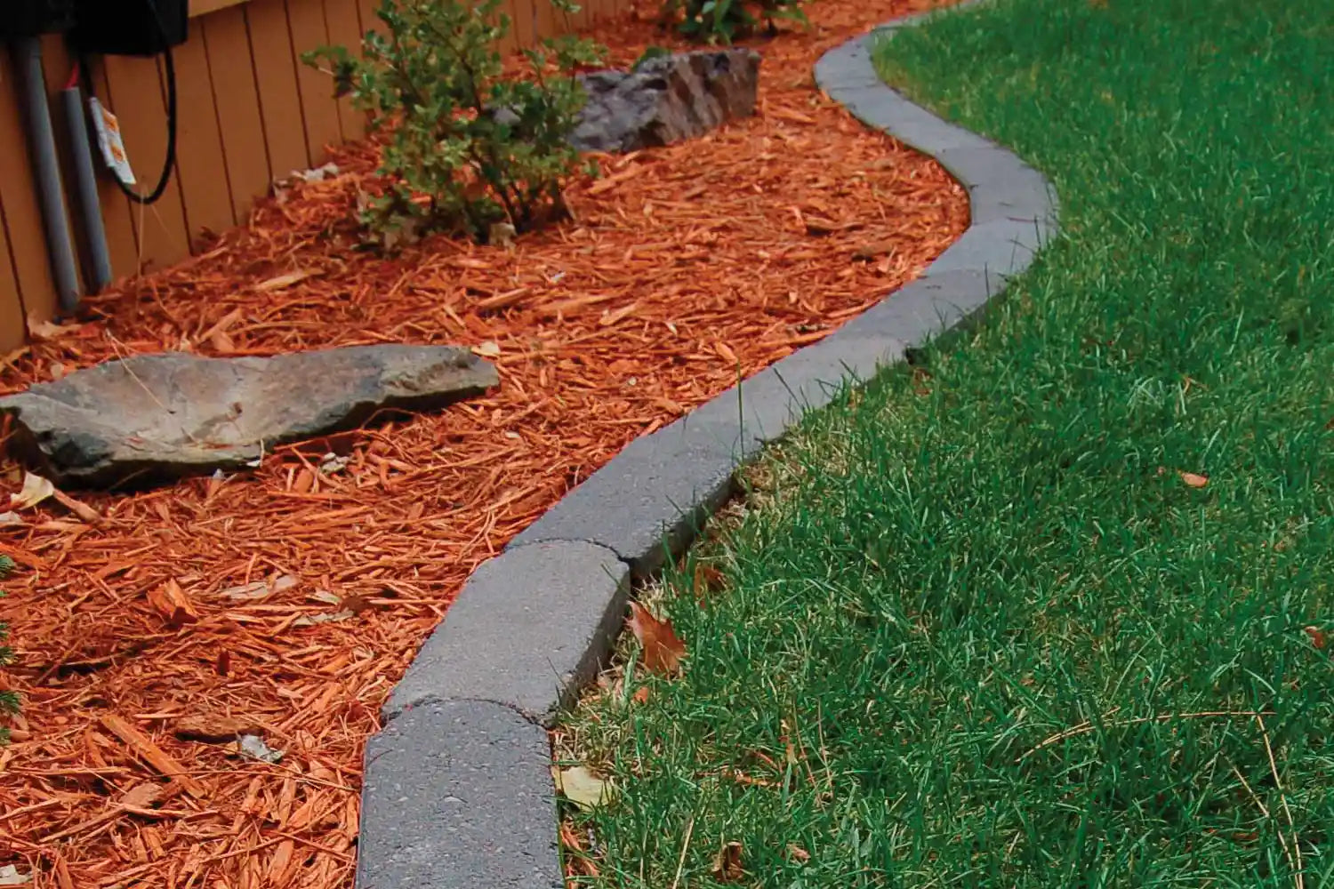 Bullet Edger separating a mulch bed from sod