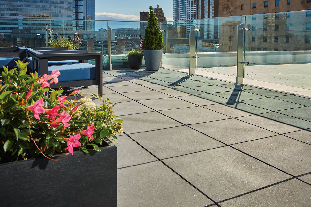 Skyland Paver patio looking out on a city skyline with flowers in the foreground